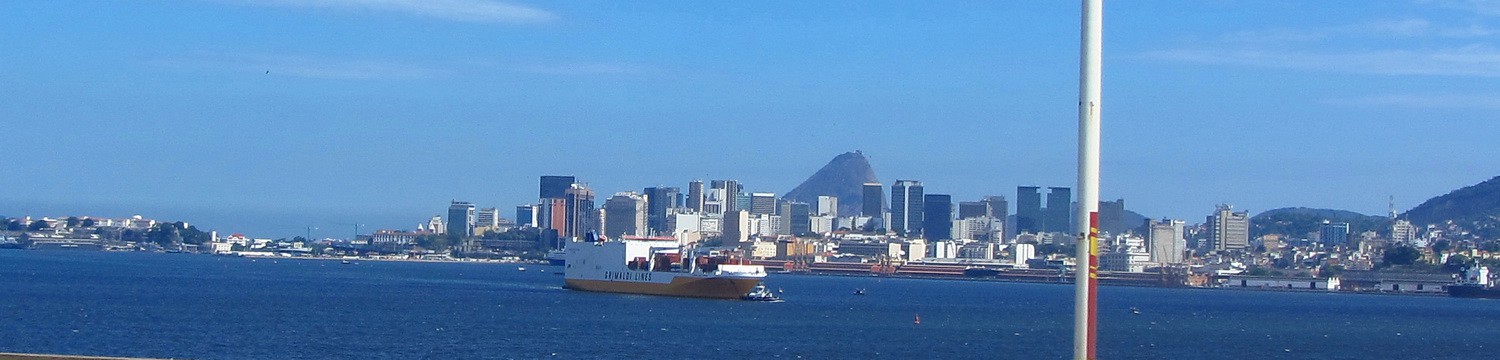 The center of Rio seen from the bridge to Niteroi with a white-orange vessel of Grimaldi, the line we came to South Ameirca